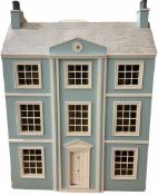 Georgian style wooden double fronted three-storey dolls house with pale blue stucco finish under a f