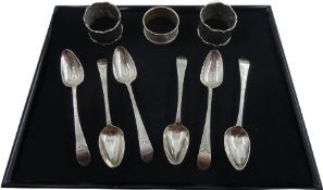 Set of six Georgian teaspoons and three silver napkin rigs