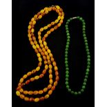 Long single strand amber type bead necklace and a nephrite bead necklace