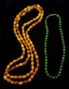 Long single strand amber type bead necklace and a nephrite bead necklace