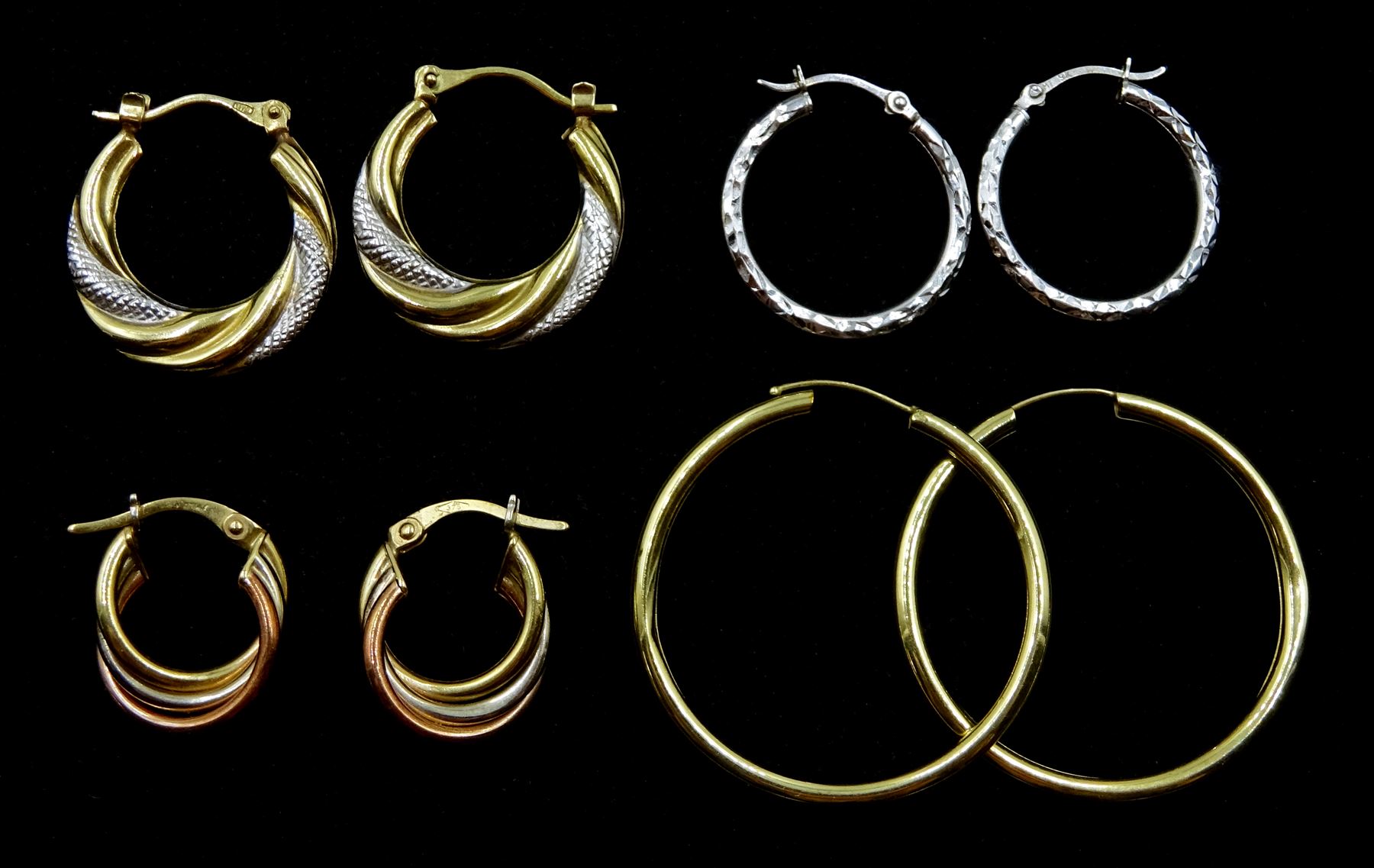 Four pairs of 9ct white and yellow gold hoop earrings