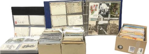 Two modern loose leaf albums and a large quantity of loose Edwardian and later postcards predominant