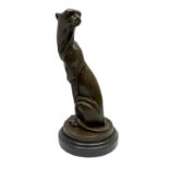 Stylised bronze figure of a seated Cheetah after 'Milo' with foundry mark on circular base