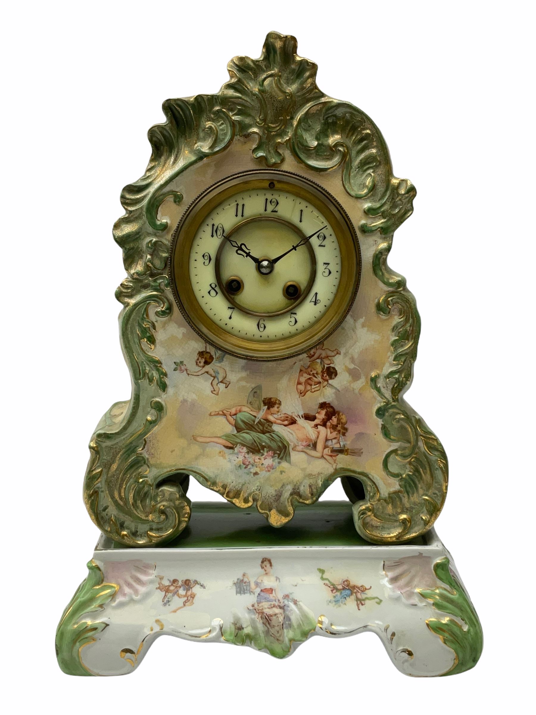 An early 20th century French porcelain clock with rococo scrolling in a cartouche form with gilt hig