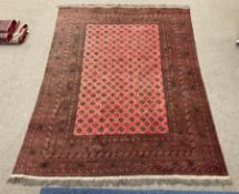 Large red ground Persian Bokhara carpet