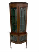 Early 20th century mahogany bow front corner cabinet on stand