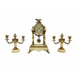 A late 19th century French portico clock with a pair of matching double light candelabra