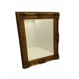 Large rectangular wall mirror in heavy swept gilt frame