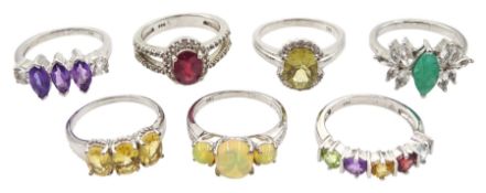 Seven silver stone set rings including emerald and topaz