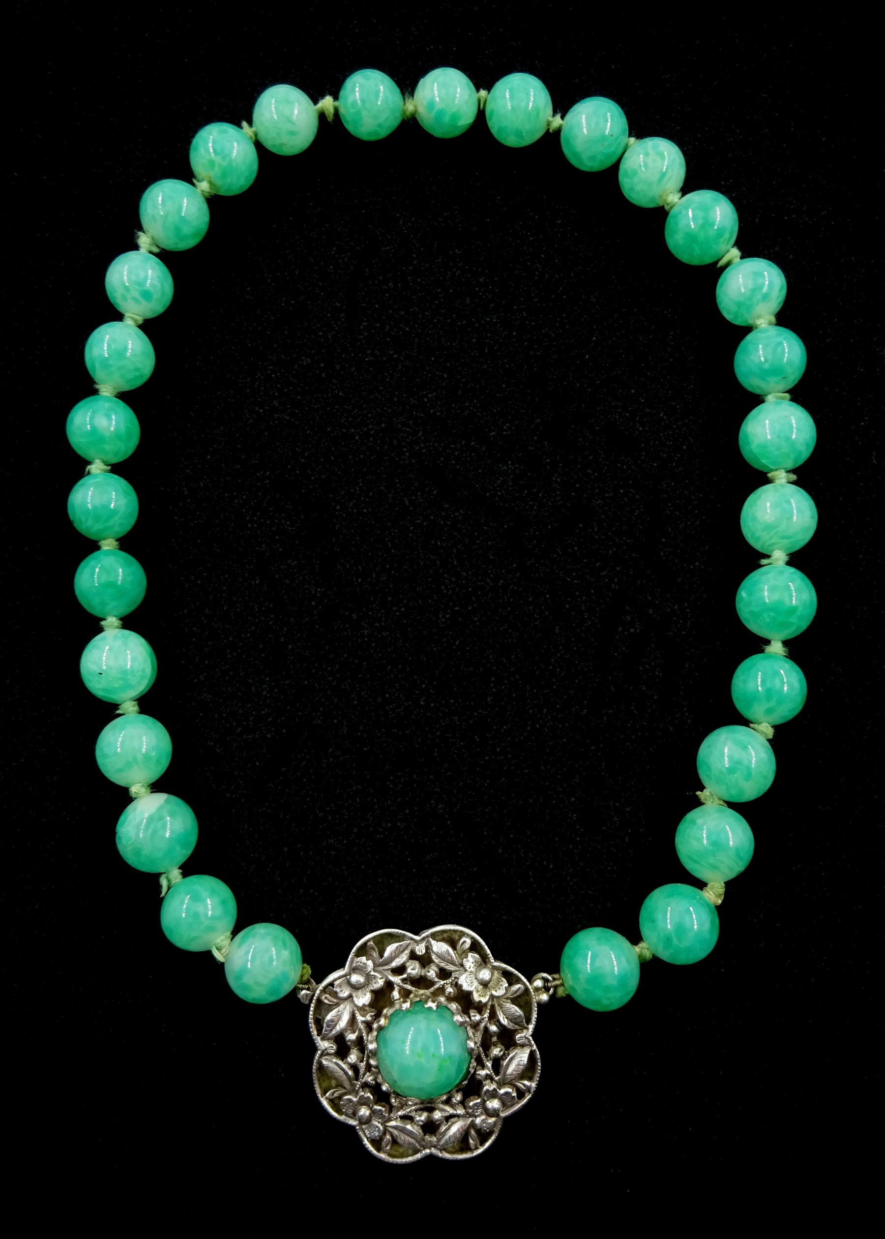 Chinese jade bead necklace with silver open work clasp with a cabochon greenstone/possibly jade bead