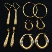 Three pairs of gold hoop earrings and two other pairs of pendant earrings