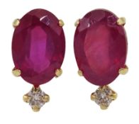 Pair of gold oval ruby and round brilliant cut stud earrings