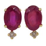 Pair of gold oval ruby and round brilliant cut stud earrings