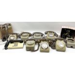 Collection of vintage telephones and spare parts including handsets.