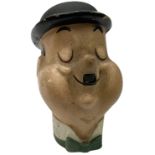 Mid-20th century composition bust of Oliver Hardy depicted smiling with eyes closed and wearing a to