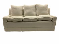 Three seat sofa upholstered in natural white linen