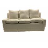 Three seat sofa upholstered in natural white linen