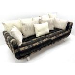 Grande four seat sofa upholstered in patterned fabric with contrasting scatter cushions