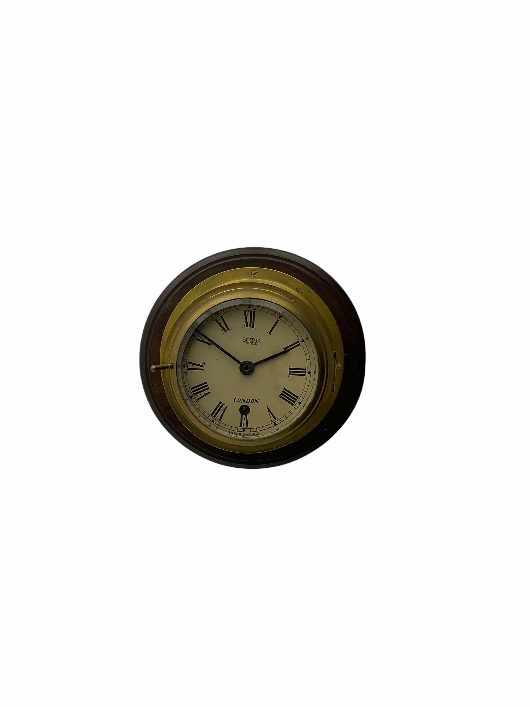 20th century brass cased bulkhead clock mounted on a circular mahogany base