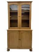 Victorian polished pine bookcase on cupboard
