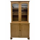 Victorian polished pine bookcase on cupboard