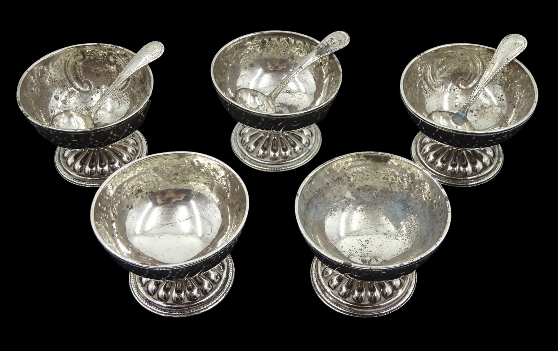 Five Victorian silver pedestal salt cellars and three spoons by George Unite