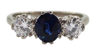 White gold three stone oval sapphire and round brilliant cut diamond ring