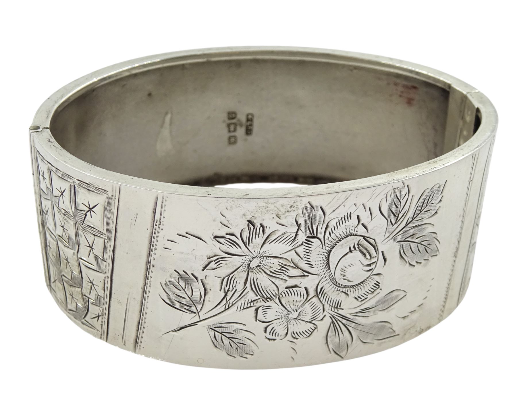 Silver hinged bangle with bright cut foliate decoration by Kenart Ltd