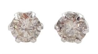 Pair of platinum round brilliant cut diamond stud earrings