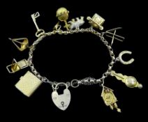 Gold bracelet with heart locket and twelve charms including cuckoo clock