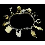 Gold bracelet with heart locket and twelve charms including cuckoo clock