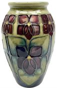 Moorcroft vase of ovoid form decorated in the 'Violet' pattern by Sally Tuffin upon green ground