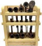 Pipes and two tiered wooden rack together with eleven pipers