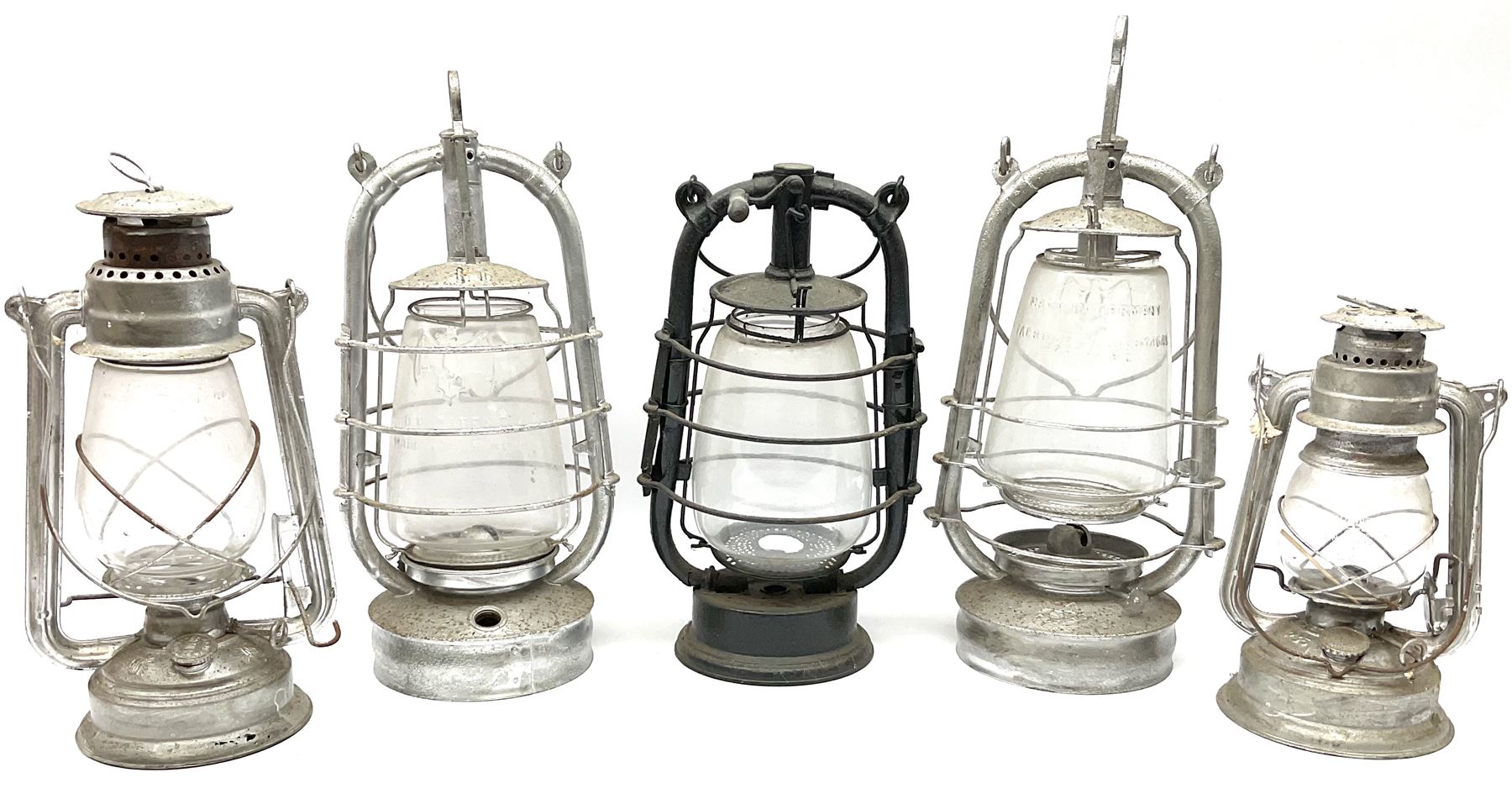 Five cast metal oil lanterns