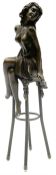 Art Deco style bronze modelled as a bare chested female figure seated upon a chair