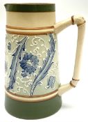 James Macintyre 'Gesso Faience' jug decorated with tubelined flowers and scrolling foliage in tones