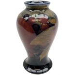 Moorcroft vase of baluster form decorated in the 'Pomegranate' pattern upon dark blue ground with im