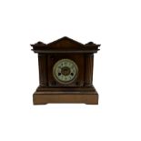 A light mahogany eight-day striking German mantle clock manufactured in the late 19th century by the