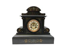 A large late 19th century Belgium slate mantle clock with an arched pediment and supports embellishe