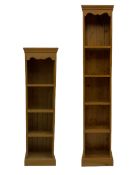 Two narrow pine open bookcases