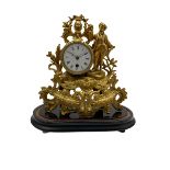 A late 19th century French 8-day timepiece mantle clock in a spelter case on an ebonised oval plinth