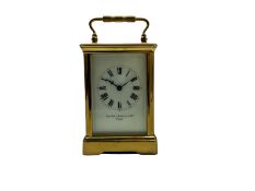 A mid-19th century French timepiece carriage clock in a corniche case with a white enamel dial and R