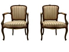 A pair of French walnut armchairs