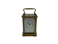 A late 19th century French timepiece carriage clock in a corniche case with a white enamel dial and