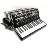 Italian E. Soprani piano accordion in black and silver case