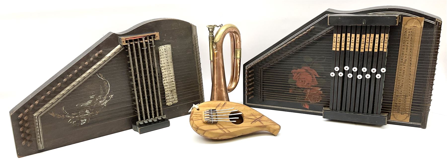 Two continental autoharps; military style copper and brass bugle; and a gourd five-key thumb piano '