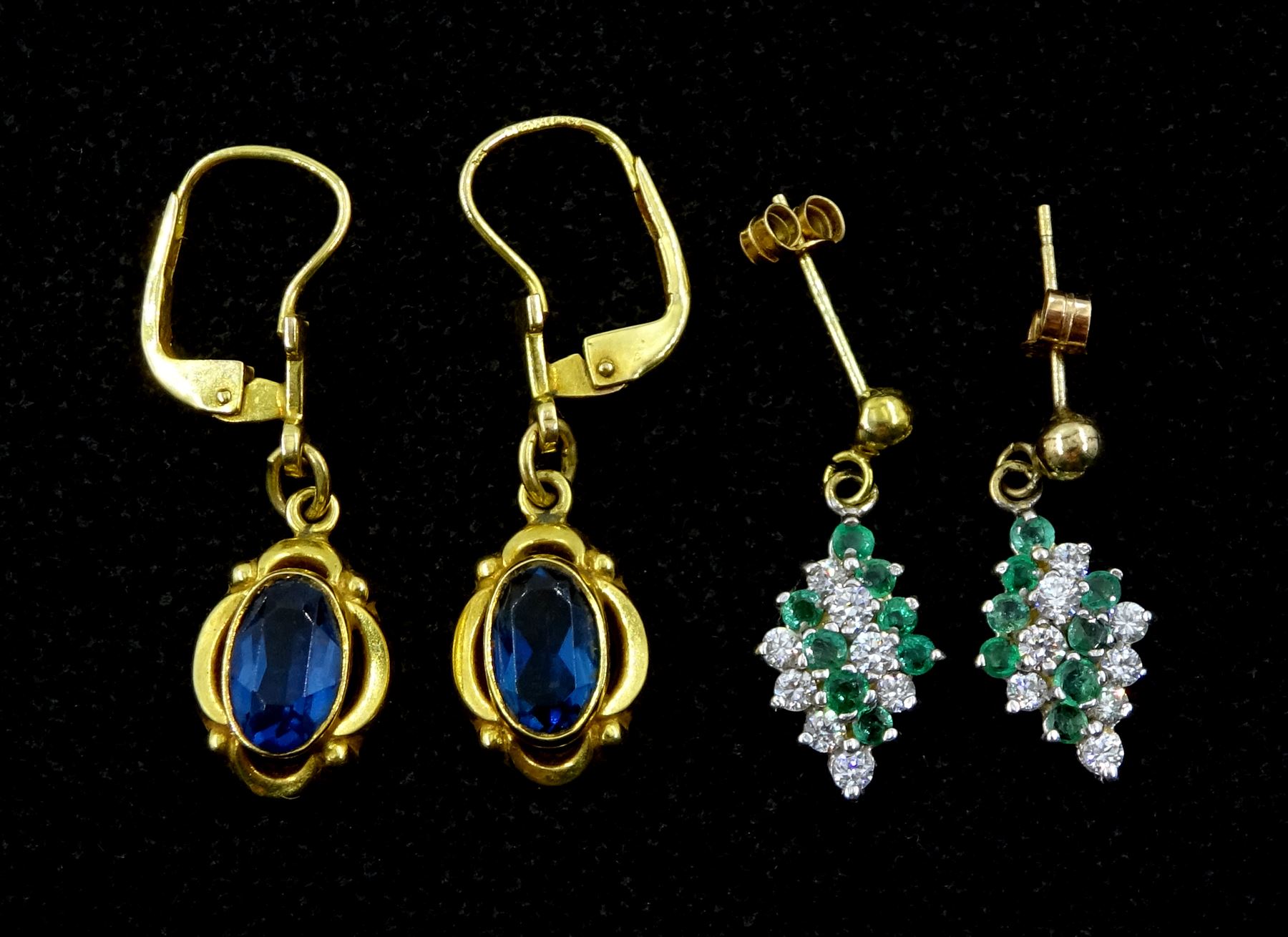 Pair of gold blue stone set pendant earrings and a pair of gold cubic zirconia and emerald pendant s