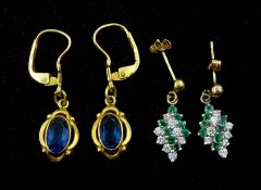 Pair of gold blue stone set pendant earrings and a pair of gold cubic zirconia and emerald pendant s