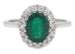 White gold oval emerald and round brilliant cut diamond ring
