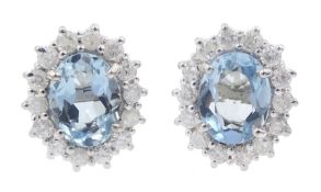 Pair of 18ct white gold oval aquamarine and round brilliant cut diamond cluster stud earrings